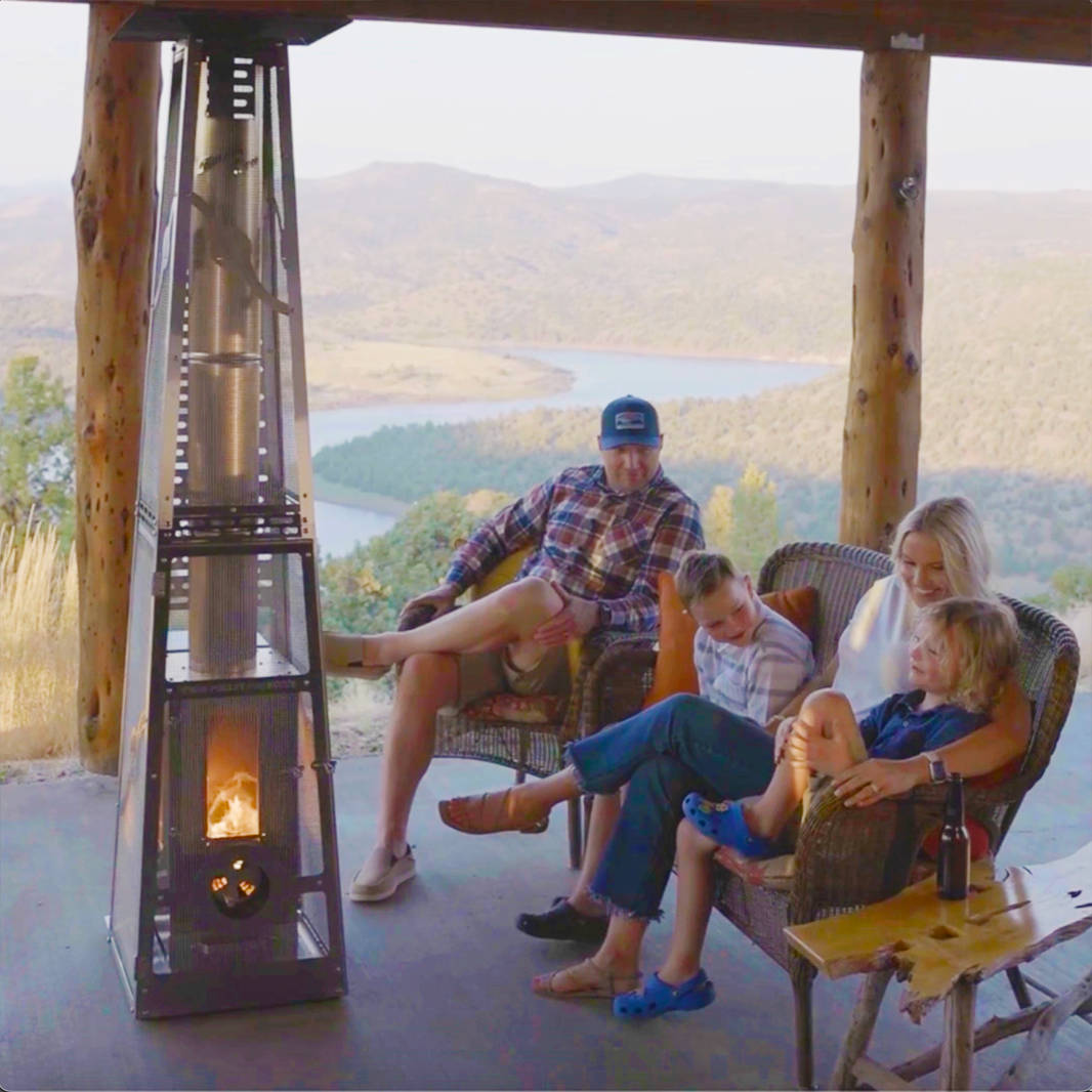 Family-gathered-around-a-Timber-Stove-with-Safety-Cage